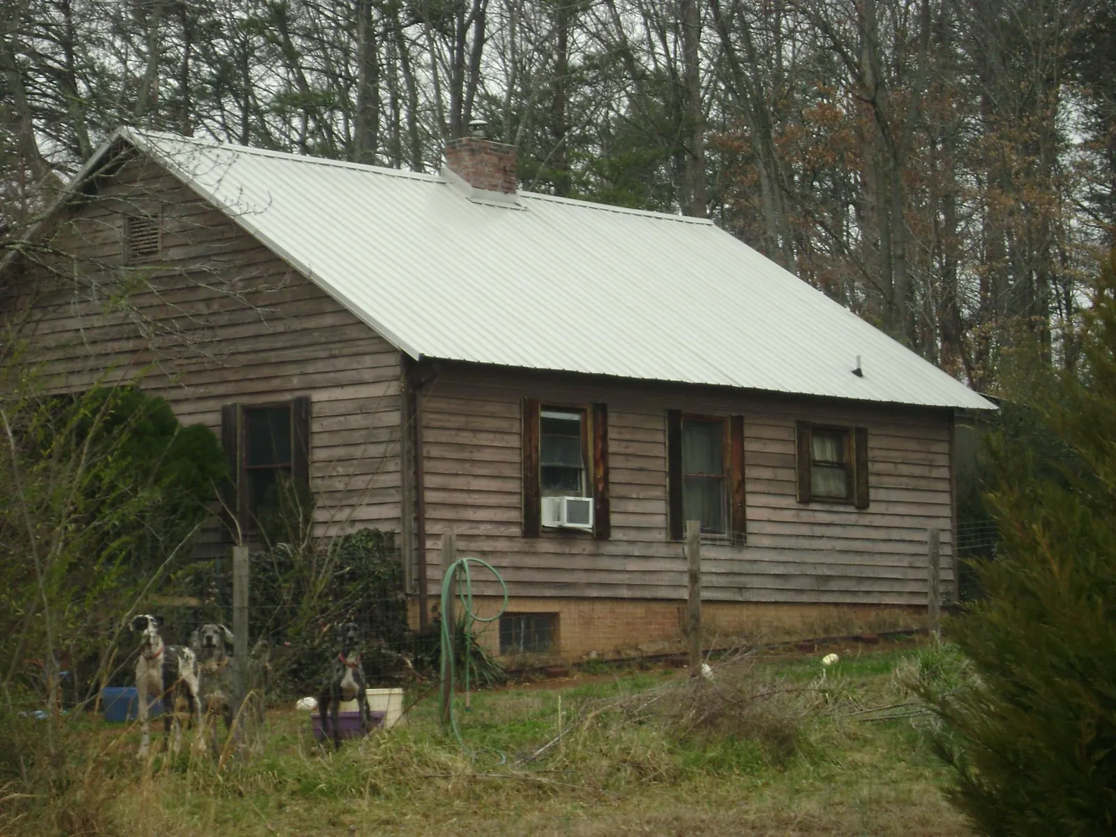 White metal roof on an old wood sided farmhouse, from a Metal Roof Installation job in Pascoag